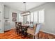 Traditional dining room with wood floors, shuttered windows, and contemporary lighting at 6135 S Paris St, Englewood, CO 80111