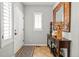 Inviting foyer featuring a console table, mirror, and tiled flooring at 6135 S Paris St, Englewood, CO 80111