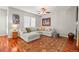 Cozy living room featuring a plush sectional sofa, colorful rug, and ample natural light at 6135 S Paris St, Englewood, CO 80111