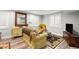 Living room featuring a sofa with accent pillows, hardwood floors, and plantation shutters at 6135 S Paris St, Englewood, CO 80111