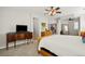 Well-lit main bedroom with access to the Primary bath and seating area at 6135 S Paris St, Englewood, CO 80111