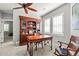 Office with a built-in bookcase desk combination, plantation shutters, and a ceiling fan at 6135 S Paris St, Englewood, CO 80111