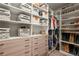 Organized walk-in closet featuring custom shelves, drawers, rods, and storage bins for maximum storage capacity at 6135 S Paris St, Englewood, CO 80111