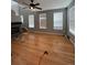 Spacious living room with fireplace, hardwood floors, and abundant natural light from large windows at 10638 Cherrybrook Cir, Highlands Ranch, CO 80126