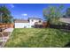 Expansive backyard with lush lawn, wooden deck, garden beds, and privacy fence at 9740 W 104Th Dr, Westminster, CO 80021