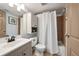 Bathroom featuring a shower with white tiling, vanity, and efficient storage at 9740 W 104Th Dr, Westminster, CO 80021