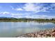 Scenic lake view with blue skies and distant mountains at 9740 W 104Th Dr, Westminster, CO 80021