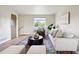 Cozy living area with modern sofas, a stylish rug, and abundant natural light at 9740 W 104Th Dr, Westminster, CO 80021