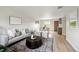 Inviting living room showcasing a neutral color palette, hardwood floors, and an open layout to the dining area at 9740 W 104Th Dr, Westminster, CO 80021