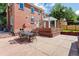 Outdoor patio area with seating and pergola, adjacent to a brick home at 5022 E 17Th Ave, Denver, CO 80220