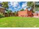 Large backyard with grassy lawn and brick structures at 5022 E 17Th Ave, Denver, CO 80220