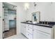 Elegant bathroom with double vanity and walk-in closet access at 5022 E 17Th Ave, Denver, CO 80220