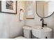 Small modern bathroom with pedestal sink and white toilet at 5022 E 17Th Ave, Denver, CO 80220