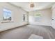 Bright bedroom with neutral carpeting and three large windows at 5022 E 17Th Ave, Denver, CO 80220