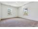 Well-lit bedroom with neutral carpeting and two large windows at 5022 E 17Th Ave, Denver, CO 80220