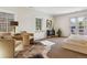 Bright and airy bedroom with balcony access and a cowhide rug at 5022 E 17Th Ave, Denver, CO 80220