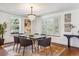 Bright dining room with glass table, chandelier, and hardwood floors at 5022 E 17Th Ave, Denver, CO 80220