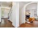 Bright entryway with hardwood floors and view to living room and staircase at 5022 E 17Th Ave, Denver, CO 80220