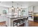 Modern white kitchen with stainless steel appliances and large island at 5022 E 17Th Ave, Denver, CO 80220