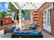 Outdoor patio with seating area, pergola, and brick walls at 5022 E 17Th Ave, Denver, CO 80220