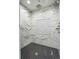 Large walk-in shower with marble tile and rainfall shower head at 5022 E 17Th Ave, Denver, CO 80220