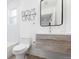 Modern bathroom boasting sleek vanity, minimalist design, and stylish black framed mirror at 6088 S Lakeview St, Littleton, CO 80120