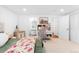 Bedroom with a queen bed and white walls, carpet floors, and a well-lit study area with desk and chair in the distance at 6088 S Lakeview St, Littleton, CO 80120