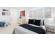 Well lit bedroom features neutral carpet, blinds and sporty decorations at 6088 S Lakeview St, Littleton, CO 80120