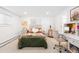Bright bedroom with a queen bed, white walls, carpet floors, and a well-lit study area with desk and chair at 6088 S Lakeview St, Littleton, CO 80120