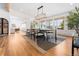 Dining room with hardwood floors, modern light fixture, and big windows showing lots of light at 6088 S Lakeview St, Littleton, CO 80120