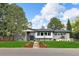 Charming single-story home with lush front lawn, mature trees, and gray exterior at 6088 S Lakeview St, Littleton, CO 80120