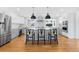 Modern kitchen featuring white cabinetry, stainless steel appliances, and a large center island at 6088 S Lakeview St, Littleton, CO 80120