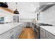 Bright kitchen features stainless steel appliances, a white tile backsplash, and an oversized center island at 6088 S Lakeview St, Littleton, CO 80120