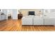 Stylish living room with wood floors, modular white sofa, and a neutral color palette at 6088 S Lakeview St, Littleton, CO 80120