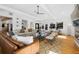 Inviting open-plan living room boasts hardwood floors, a beamed ceiling, and neutral decor at 6088 S Lakeview St, Littleton, CO 80120