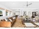 This open-plan living room features lots of natural light, beamed ceilings, and hardwood floors at 6088 S Lakeview St, Littleton, CO 80120