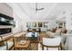 Open-plan living room features a fireplace, neutral color palette, and beamed ceilings at 6088 S Lakeview St, Littleton, CO 80120