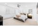 Spacious bedroom features neutral carpet, white walls, and a ceiling fan at 6088 S Lakeview St, Littleton, CO 80120