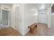 Entryway with light wood floors and a wooden bench at 2147 Prairie Smoke Dr, Monument, CO 80132