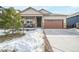 House exterior showcasing a snow-covered front yard and driveway at 2147 Prairie Smoke Dr, Monument, CO 80132