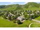 Lovely aerial view of home with mature trees and mountain views at 50 Deerwood Dr, Littleton, CO 80127