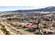 Aerial view of the community with horse barns and distant mountains at 50 Deerwood Dr, Littleton, CO 80127