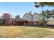 Two-story home back exterior with a spacious deck and walkout basement at 50 Deerwood Dr, Littleton, CO 80127