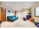 Spacious basement featuring exercise area, futon, and natural light, ideal for a home gym or recreation at 50 Deerwood Dr, Littleton, CO 80127
