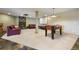 Large basement with fireplace, projector screen, and foosball table, perfect for entertainment at 50 Deerwood Dr, Littleton, CO 80127