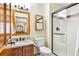 Cozy bathroom featuring granite vanity and shower with glass door, providing a functional and clean space at 50 Deerwood Dr, Littleton, CO 80127