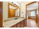 Bathroom showcasing a vanity with granite countertops and views into the bedroom at 50 Deerwood Dr, Littleton, CO 80127