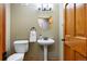 Cozy bathroom with pedestal sink and decorative mirror, offering a functional and stylish space at 50 Deerwood Dr, Littleton, CO 80127
