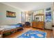 Bright bedroom with hardwood floors, dresser, and colorful rug, offering a cozy and inviting space at 50 Deerwood Dr, Littleton, CO 80127