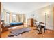 Bedroom featuring wood floors, a bay window, and ample space for furniture at 50 Deerwood Dr, Littleton, CO 80127